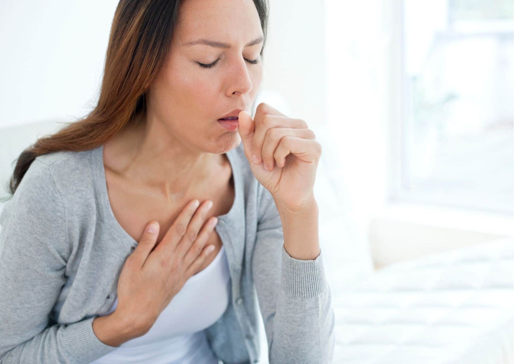 Woman coughing due to lung disease