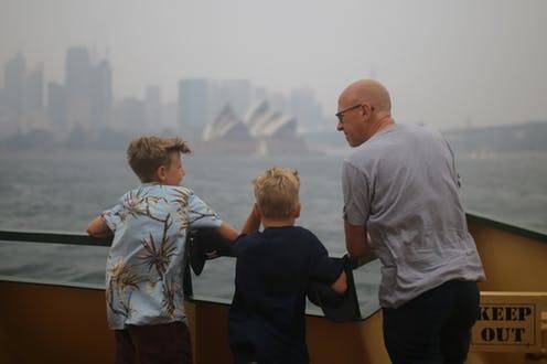 Father with kids in smokey Sydney
