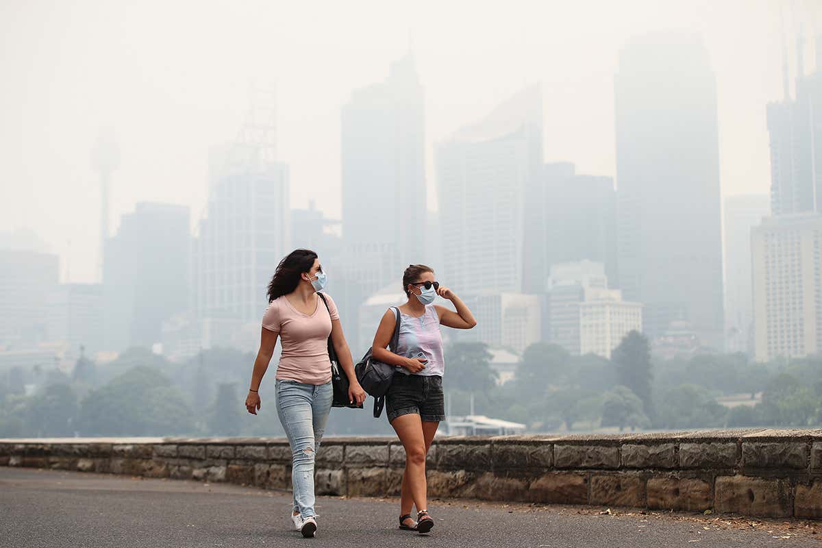 2 people walking in smoke city