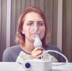 Woman using a nebuliser